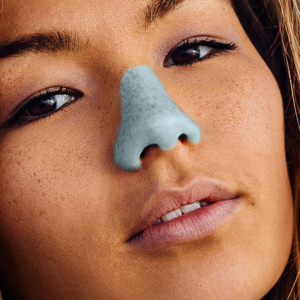 Girl wearing a blue shade of a vegan, cruelty free Nöz sunscreen